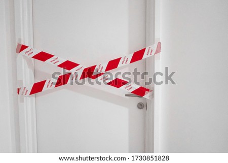 The entrance to the apartment is blocked by a protective tape. Crime scene. Do not enter.