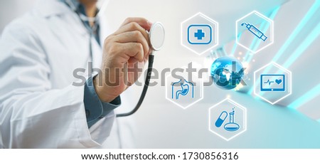 Doctor with stethoscope in hand and digital icon medical interface, medical technology network concept