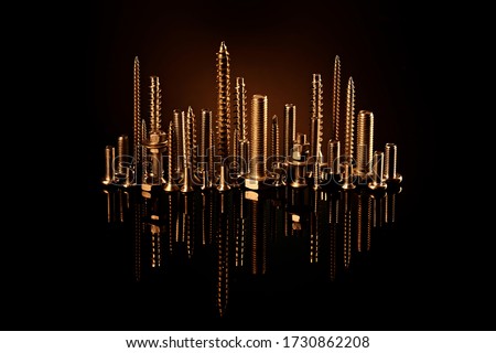 Golden city of screws, bolts and nuts with a reflection on a black background. The idea of an advertising photo of a fastener.
