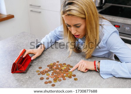 Desperate woman counting last coins