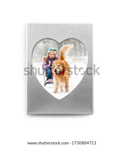 Funny winter photo in silver heart shaped frame isolated on white background