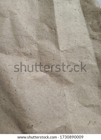 Brown wrinkled paper textured and abstract photo. Brown rough paper of crafting without printed texts, graphics and designs. 