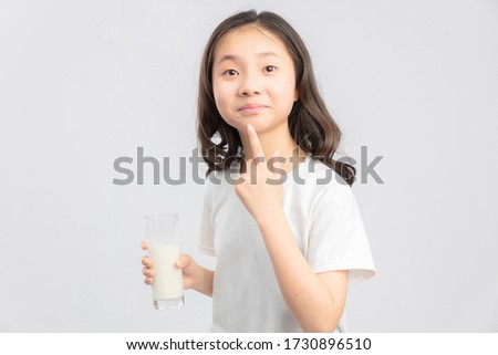 Asian elementary school girl on gray background