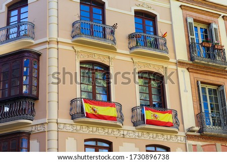 Spanish flag on the balcony of tenement house.