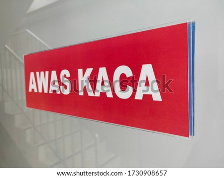 Sign "Awas Kaca" or beware there is a glass door.