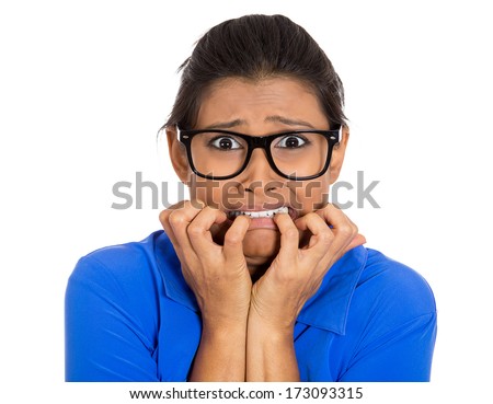 Closeup portrait of nerdy young woman with black glasses biting her nails, looking at you with craving for something, anxious, isolated on white background. Negative facial expression emotion feelings