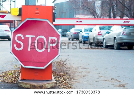 STOP road sign, close up, against the backdrop of car parking