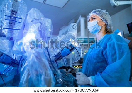 The process of carrying out a surgical operation using a modern robotic surgical system. Medical robot. Minimally invasive robotic surgery. Royalty-Free Stock Photo #1730979004
