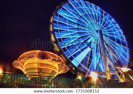 A beauty of a carnival at night. Time lapse photography of a Ferris wheel.  Royalty-Free Stock Photo #1731008152