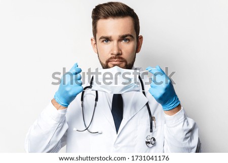 Young doctor is wearing prevention mask against virus spreading