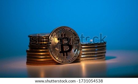 Silver Bitcoin On the table with onother currency on the neon background