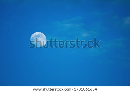 white full moon against blue sky, small clouds Royalty-Free Stock Photo #1731061654