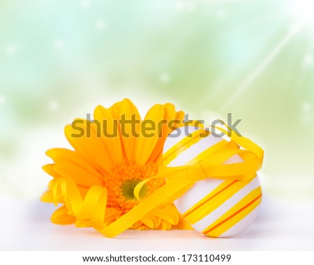 Easter eggs with gerbera daisies on nature background