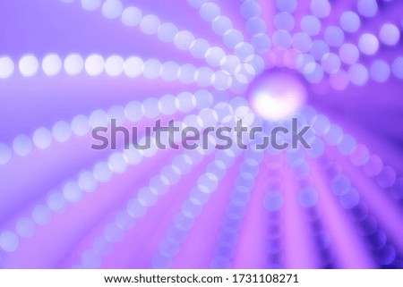 Bright aperture circles against a purple background