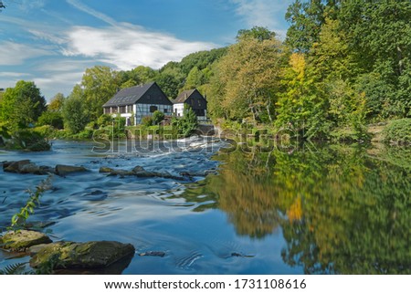 Half-timbered houses on the river bank. View on the Wipperkotten on the Wupper river, one of the landmarks of the Klingestadt Solingen in the Bergisches Land. Landscape photography Royalty-Free Stock Photo #1731108616