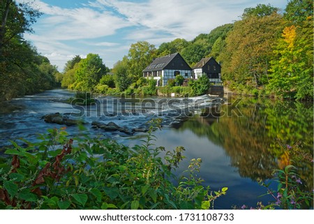 Half-timbered houses on the river bank. View on the Wipperkotten on the Wupper river, one of the landmarks of the Klingestadt Solingen in the Bergisches Land. Landscape photography Royalty-Free Stock Photo #1731108733