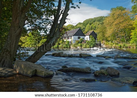 Half-timbered houses on the river bank. View on the Wipperkotten on the Wupper river, one of the landmarks of the Klingestadt Solingen in the Bergisches Land. Landscape photography Royalty-Free Stock Photo #1731108736