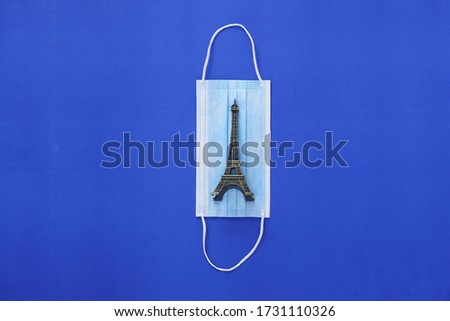 The illustration of a French country experiencing a lock down is depicted with the Eiffel Tower icon and a health mask and blue background.