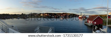 Panoramic view of the harbor, burgundy wooden houses, the landscapes and the coastline of the Koster,Sydkoster and Nordkoster islands. Kosterhavets National Park archipelago. Stromstad Bohuslan Sweden Royalty-Free Stock Photo #1731130177
