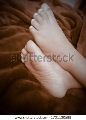 little cute baby foot crossed together