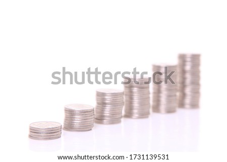 increasing columns of Japanese 100yen coins isolated on white background
