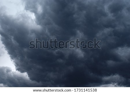 Huge scary storm cloud. Nimbostratus cloud. Thunder cloud. Royalty-Free Stock Photo #1731141538