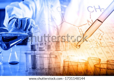 hand of scientist holding flask with lab glassware in chemical laboratory background, science laboratory research and development concept.
