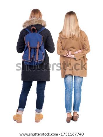 Back view of two young woman in winter jackets. Rear view people collection. backside view of person. Rear view. Isolated over white background. She clung to his girlfriend