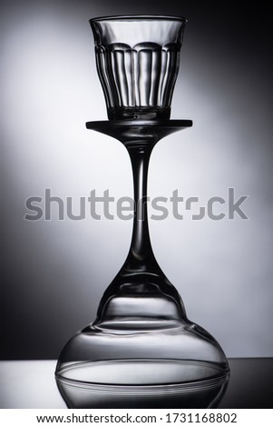empty shot glass on cocktail glass on dark background