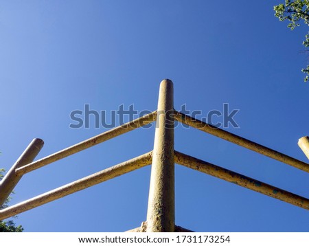 Gymnastic old iron staircase against the blue sky