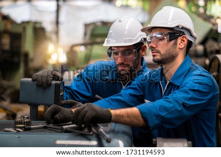 Engineers and skilled technicians are maintaining machinery. Professional technicians are working in industrial plants. Royalty-Free Stock Photo #1731194593