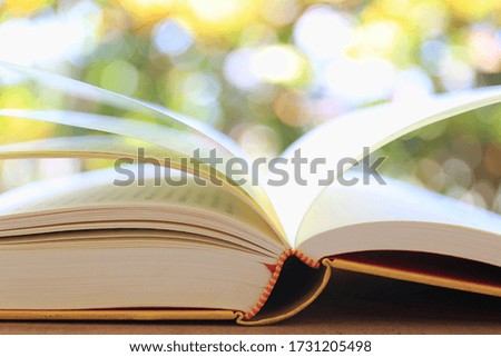 A close up of the open book in the garden Natural light as a background selective focus and shallow depth of field