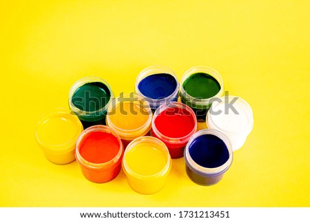 Set of 10 colors of gouache in plastic jars.