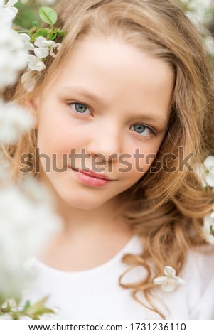 Close-up portrait of a beautiful girl with white flowers