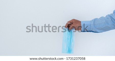 Face mask in hand isolated on white background
