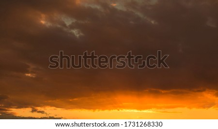 Amazing beautiful landscape. Panorama red dramatic sky sunset. Dark clouds view. Nature ecology climate. Fresh air in sunny beams. 