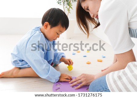 Children and teacher playing at kindergarten