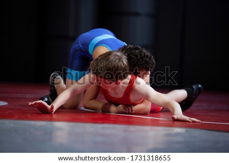 Youth wrestlers in the top and bottom position for freestyle and greco roman wrestling Royalty-Free Stock Photo #1731318655