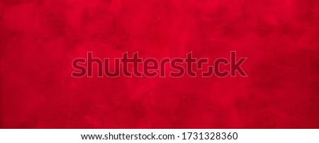 Beautiful red grunge wall background. Panoramic abstract decorative bright background. Wide angle rough stylized texture wallpaper or Web Banner with copy space for design.