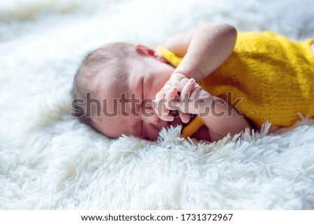Pretty Newborn Baby Boy On Textile Background. Newborn Props