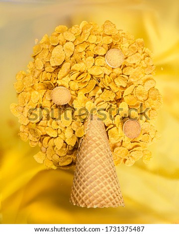 Waffle cone and corn flakes. Creative picture. Yellow