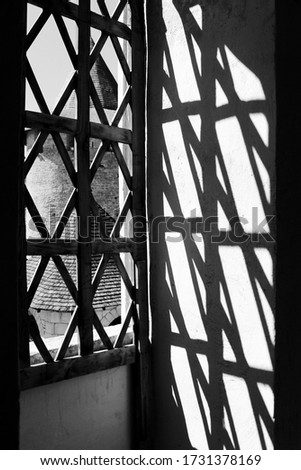 Shadows in a window of an old castle. Ancient architecture. Beautiful patterns in the window. 