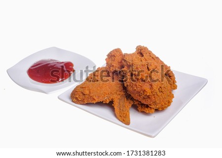 Fried chicken and chili sauce on white background