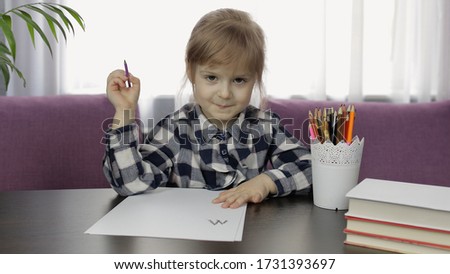 Cute small kid girl artist playing studying alone drawing picture with pencils at home. Preschool child enjoying creative art hobby activity, children distance education during coronavirus quarantine