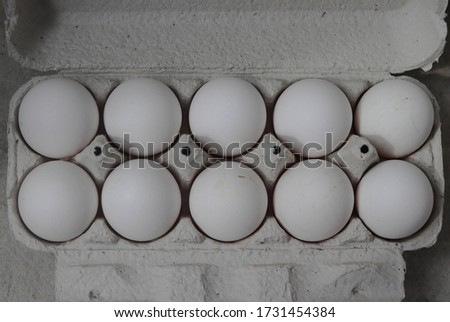 packing, box of white eggs isolated on white background, top view, 10 pieces