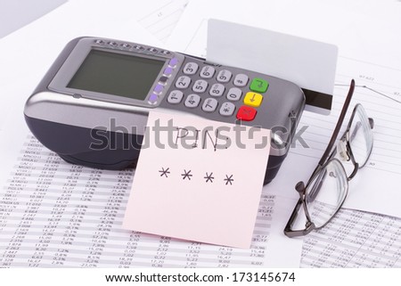 Business still-life of a payment terminal, cards, sticker, eyeglasses