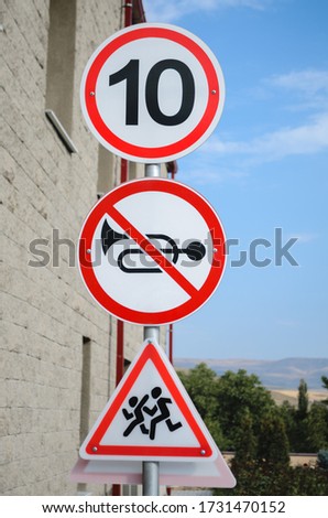 Warning signs on the road near the building.
