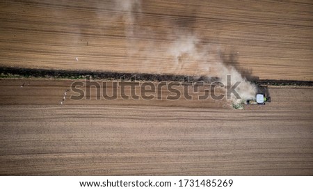 Tractor Working in Countryside. Aerial Drone Top Down View. Abstract Pattern in Landscape.