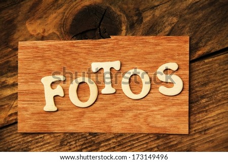 the German word FOTOS ( Photos ) on wood 