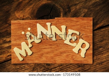 the German word MÃ?Â?NNER ( Men ) on wood 